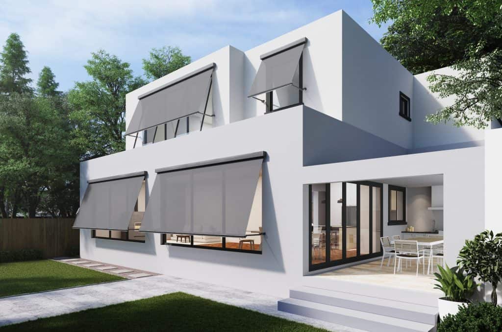 Modern white two-story house with large windows and patio.